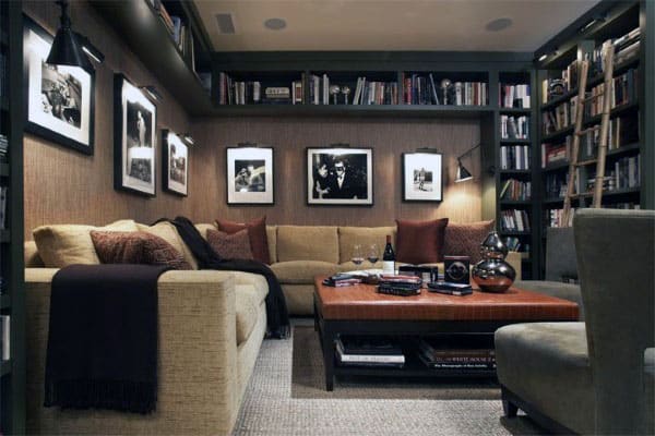 Cozy living room with a beige sectional sofa, framed photos, bookshelves like a library, and a central coffee table