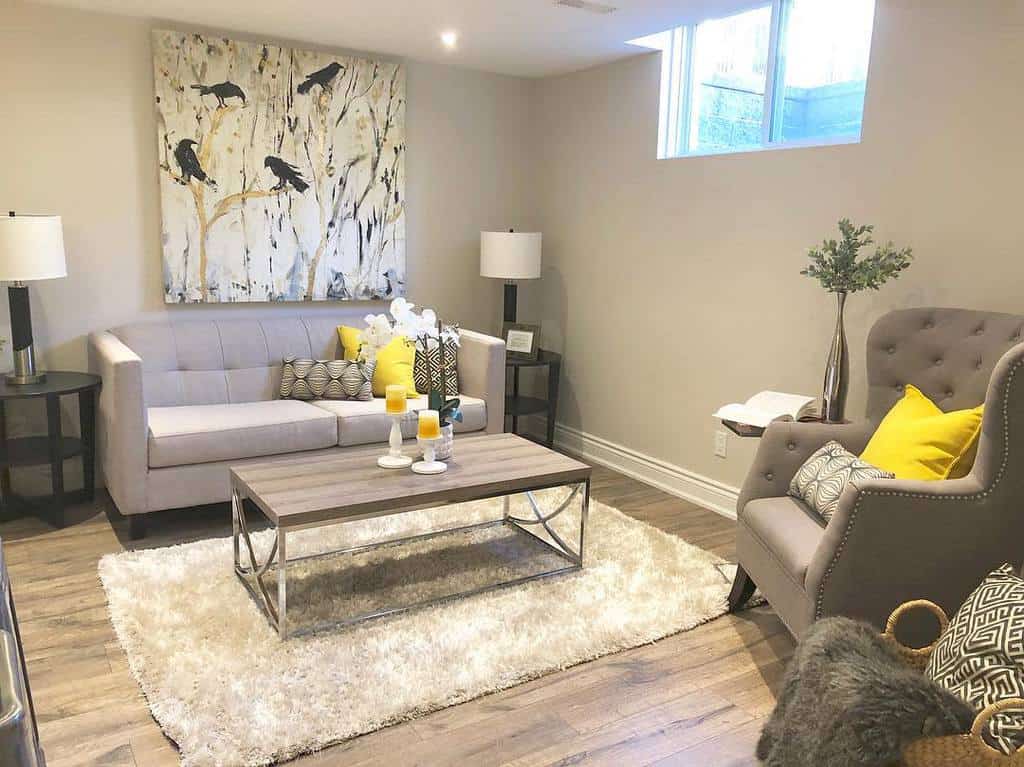 simple basement living room with gray sofa