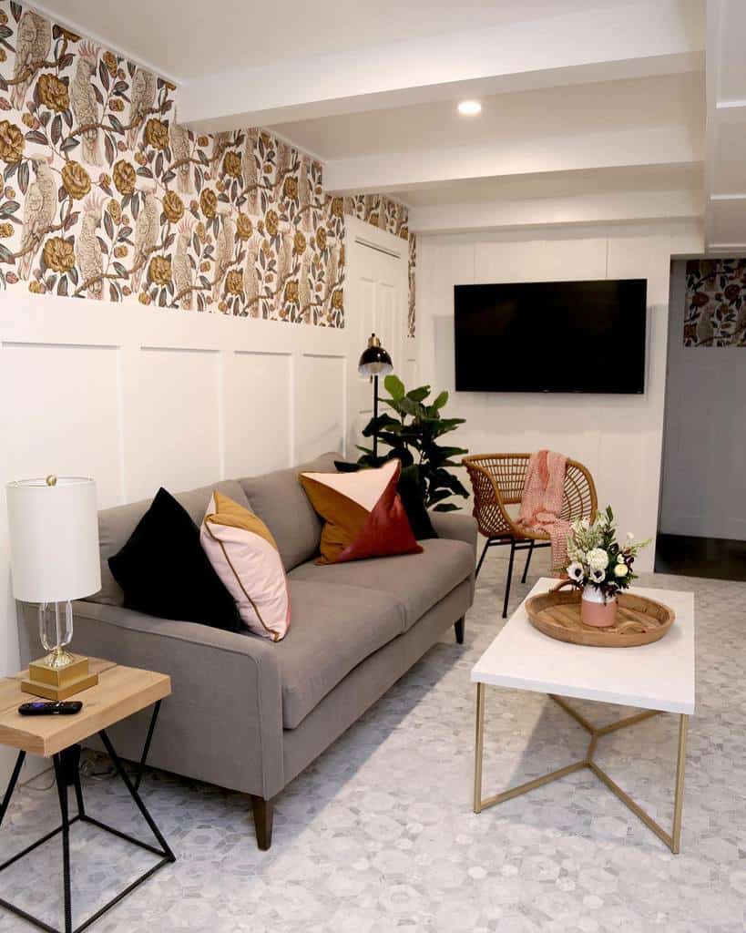 small basement living room with floral and cockatoo wallpaper