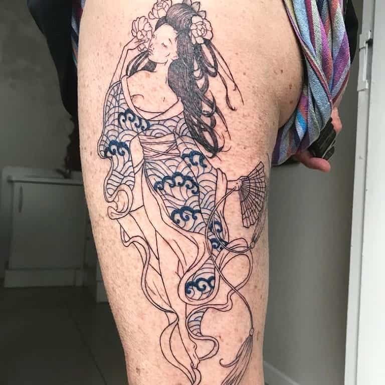 Elegant linework tattoo of a Geisha with flowing robes, intricate wave patterns, and floral hair ornaments, holding a fan in a graceful pose.