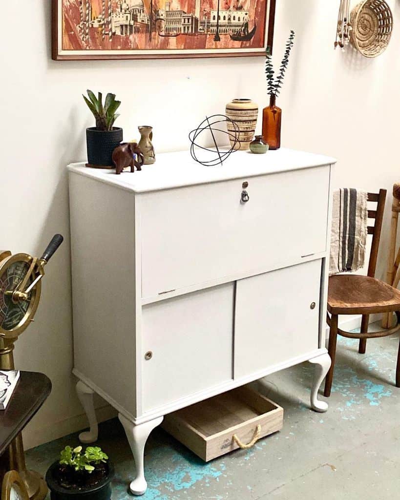 vintage white cabinet old brown chair pot plants