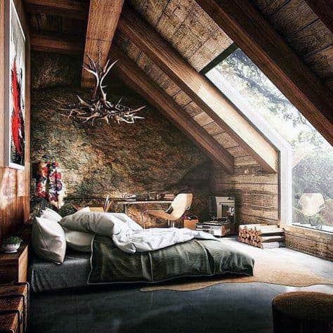 Rustic attic bedroom with sloped wooden ceiling, large skylight, and cozy natural decor.