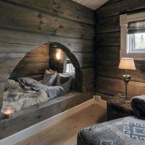 Cozy reading nook with a rustic archway, warm lighting, and soft pillows.
