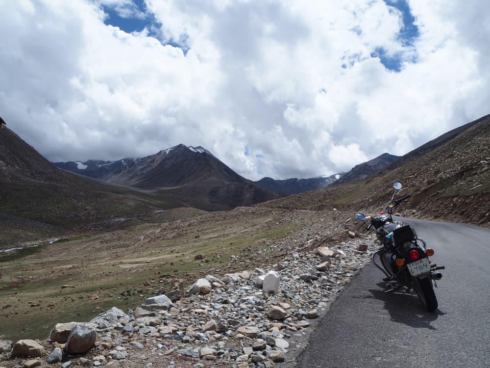 lonely motorbike parked on lonely road in the himalayas