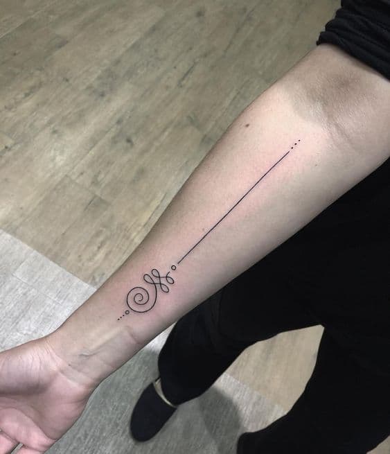 Minimalist Unalome tattoo on the forearm, featuring a long, elegant line symbolizing life's journey, spiritual growth, and inner peace.