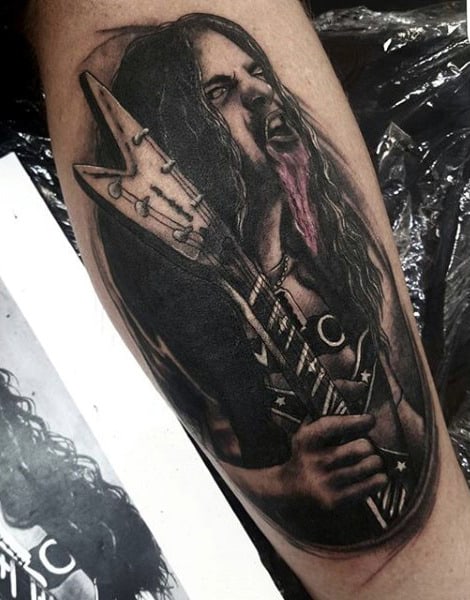 Longhaired Loud Singer With Guitar Tattoo On Legs For Guys