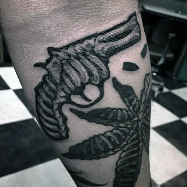 Loop Patterned Pistol And Flower Tattoo On Calves For Men
