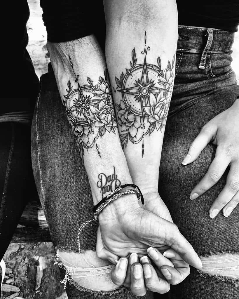 Matching compass mother-daughter tattoos with flowers, with a 'Dad' tattoo visible on one wrist