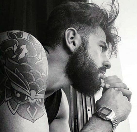 Owl tattoo with roses on a shoulder