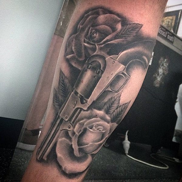Lovely Rose And Pistol Tattoo On Lower Legs For Guys
