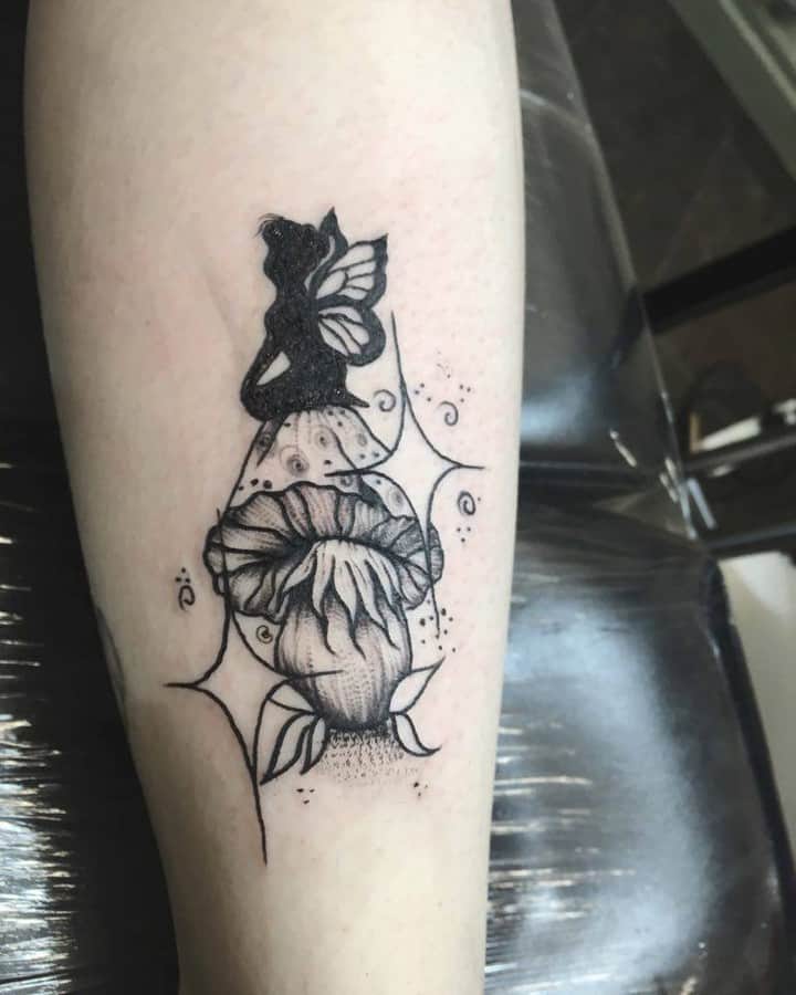 Lovely Silhouette Fairy Sitting On A Mushroom Tattoo
