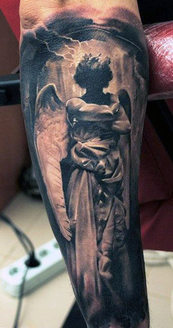 Tattoo of a dark angel with wings and a crown on a person's forearm