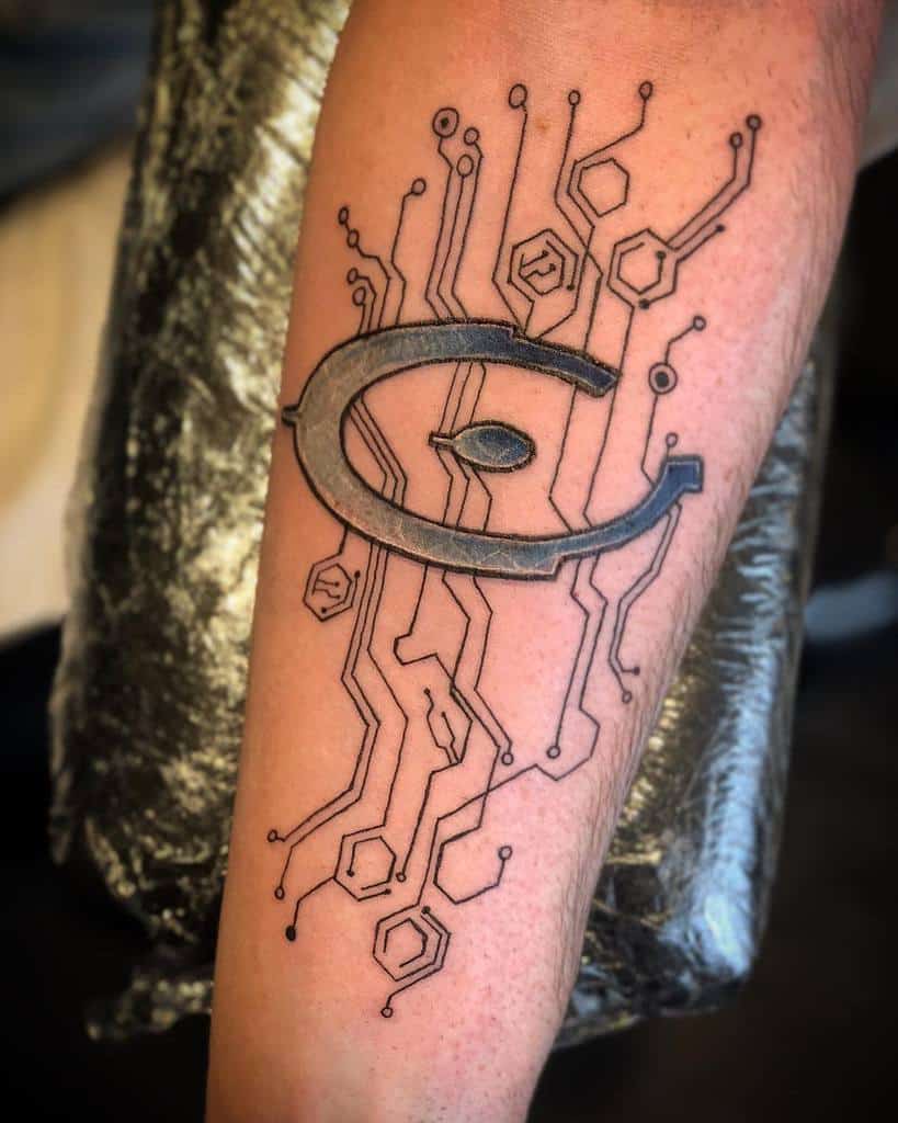 Futuristic Halo tattoo of the Forerunner symbol, integrated with intricate circuit-like designs, inked on the forearm for a sci-fi aesthetic.
