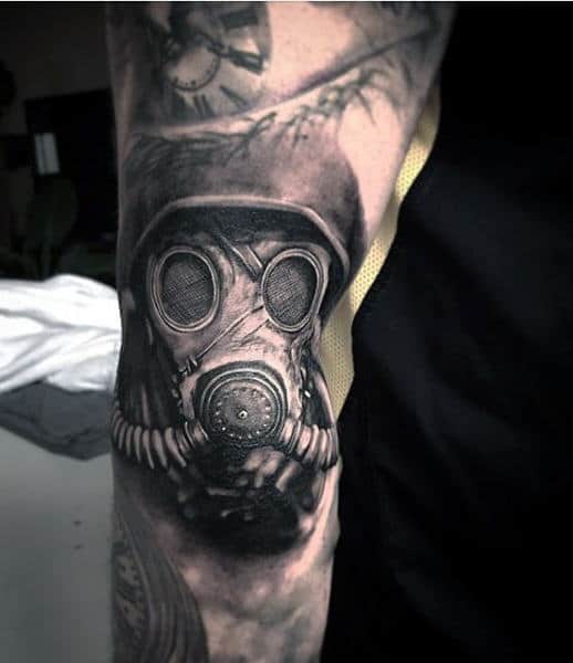 Lower Arm Gas Mask Male Tattoo With Clock In Black Ink