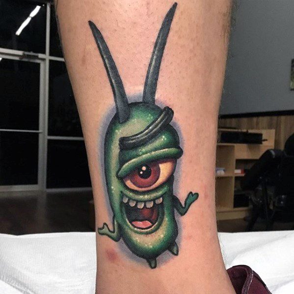 Detailed Plankton tattoo on the leg with a mischievous grin, one red eye, and 3D shading that adds depth and personality.