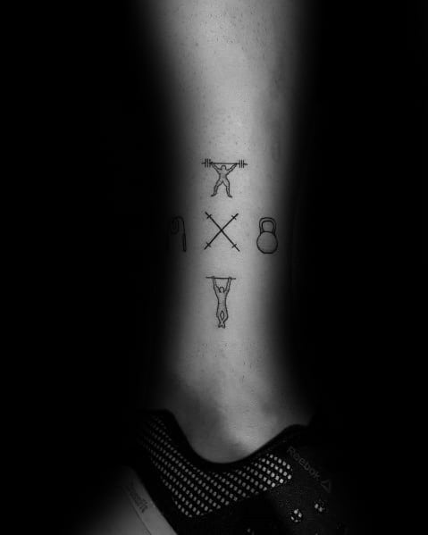 Minimalist CrossFit tattoo on the leg featuring icons of weightlifting, jump rope, kettlebell, pull-ups, and barbells, symbolizing strength and fitness.