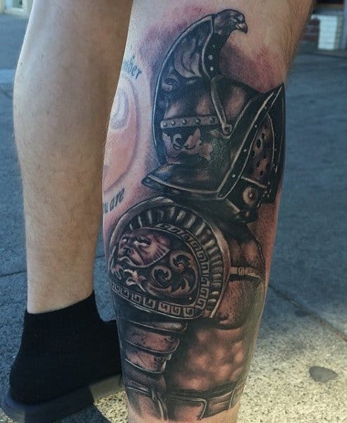 Tattoo of a Roman gladiator on a person's calf, showcasing detailed armor and helmet