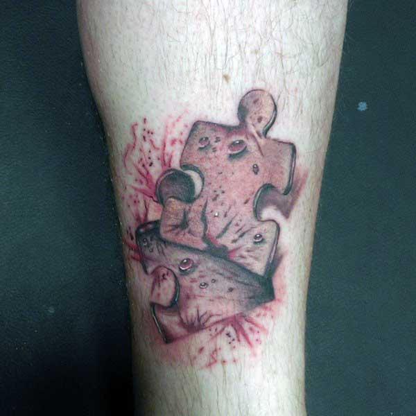 Lower Leg Guys Tattoo Puzzle Piece With Torn Skin