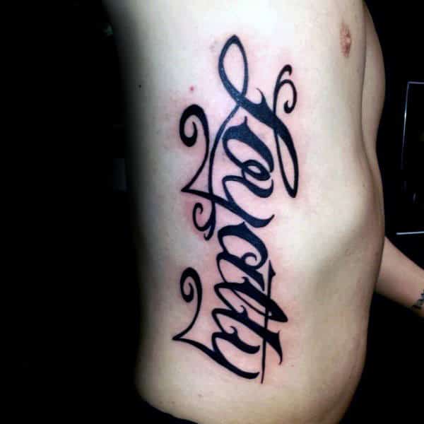 Loyalty Rib Cage Side Mens Black Ink Lettering Tattoo