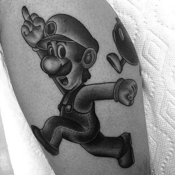 Black and grey tattoo of Luigi running with a determined expression, featuring shading details and a Bob-omb in the background.