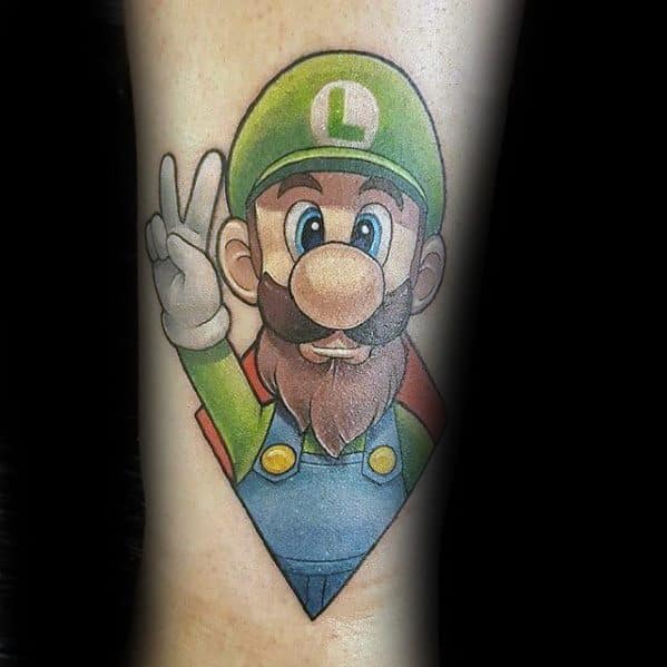 Tattoo of Luigi with a full beard, giving a peace sign, in a detailed and shaded style, framed within a geometric diamond shape.
