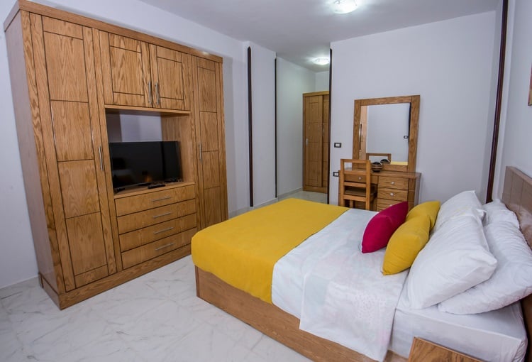 wood closet cabinet desk and vanity yellow and white bedspread 