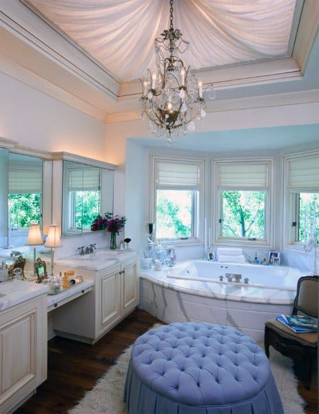 Elegant bathroom with chandelier, draped ceiling in recessed cove, and built-in whirlpool tub.