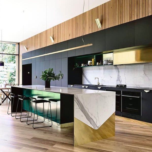 Modern black kitchen with gold accents, marble countertops, and a sleek island design.