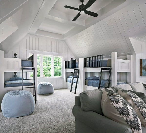 Spacious bonus room featuring built-in bunk beds, cozy bean bags, and a vaulted ceiling with a ceiling fan.