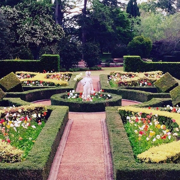 hedge-lined walkway with rotunda centerpiece sculpture