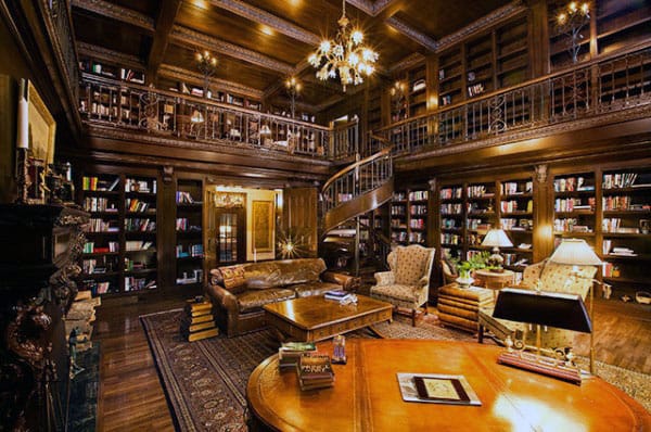 A cozy, rustic library with a spiral staircase, leather sofa, and shelves brimming with books