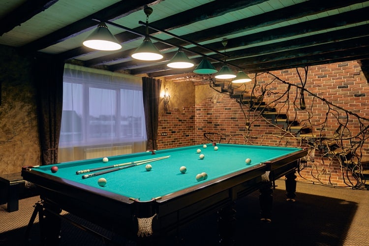 basement billiard room pool table track lighting brick wall 