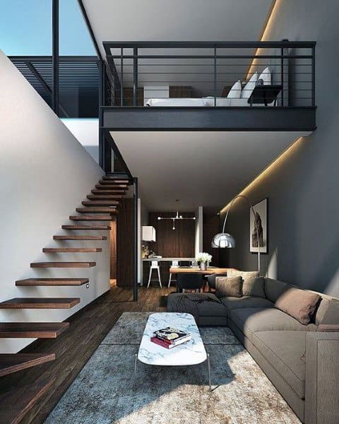 Modern loft with a floating staircase, stylish living area, and open mezzanine bedroom.