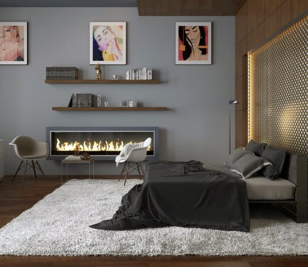 Modern bedroom with a lit fireplace, artwork on walls, and a neatly made bed
