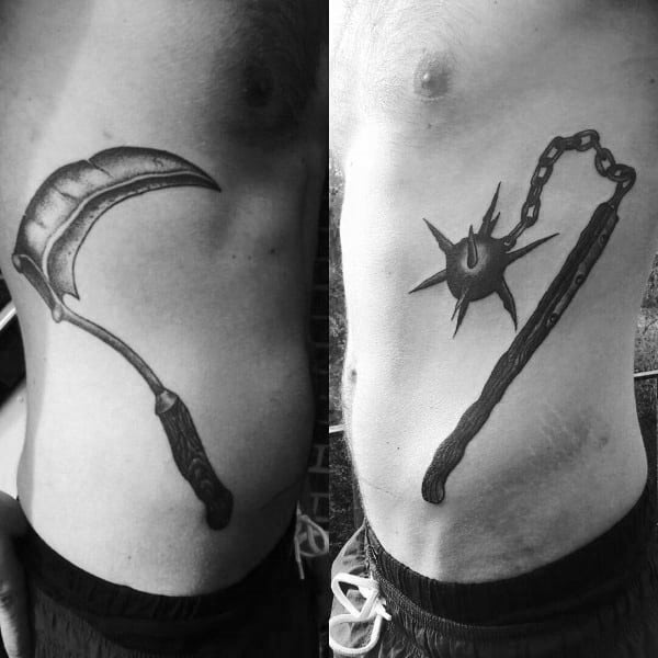 Black and gray tattoos featuring a detailed sickle on one side and a spiked mace with a wooden handle on the other, symbolizing power and mortality.