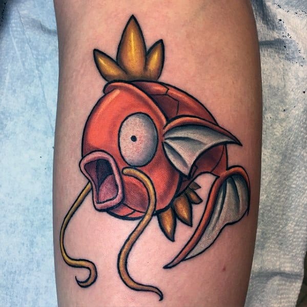 Clean and vibrant Magikarp tattoo with bold outlines, detailed shading, and an expressive face on a smooth patch of skin.