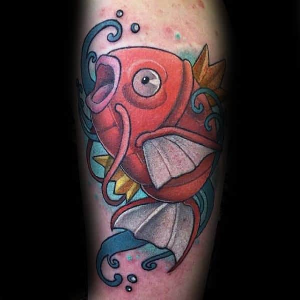 Bright Magikarp tattoo with swirling blue waves, bold outlines, and vibrant shading for a dynamic underwater effect.