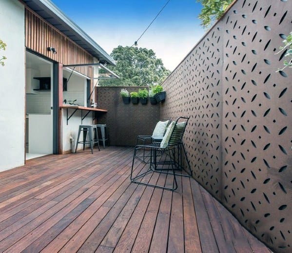 wood deck with pattern metal privacy fence