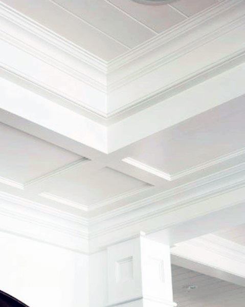 Elegant white crown molding with intricate details, highlighting a sophisticated ceiling design