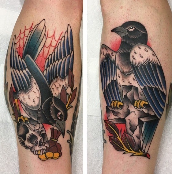 Traditional-style magpie tattoo on the leg, featuring bold black, blue, and red tones with skull, gold coins, and spider web for a dramatic look.
