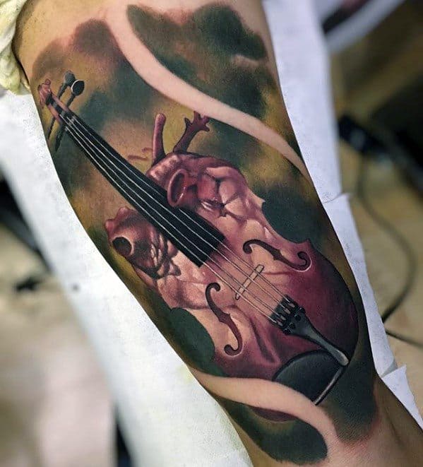 Striking tattoo of a human heart seamlessly transformed into a violin, symbolizing passion and emotion, with rich red tones and flowing ribbon-like elements.