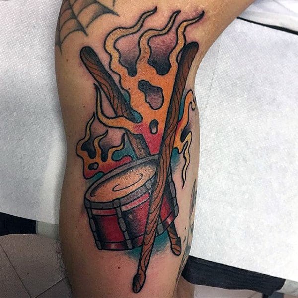 Male Arm Tattoo Of Drums With Sticks And Flames
