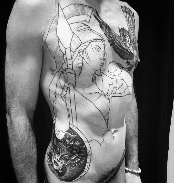 Large Athena chest and torso tattoo in progress, featuring bold outlines, owl in flight, spear, and detailed Medusa shield on the hip