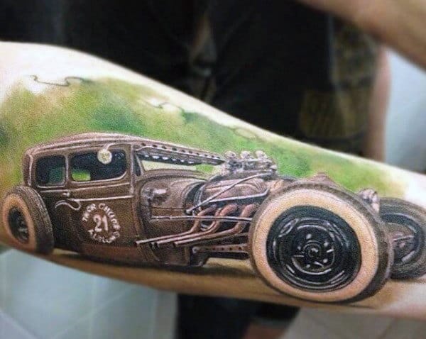 Tattoo of a vintage hot rod car on an arm, featuring detailed wheels and engine components
