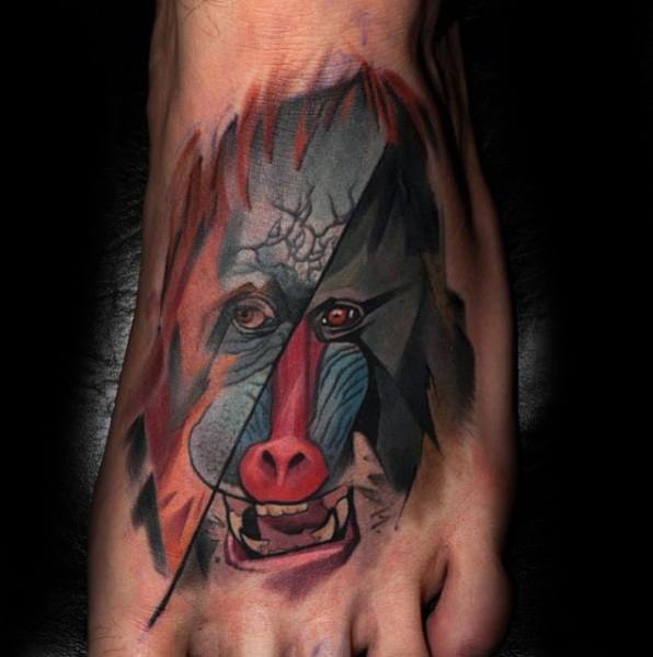 Abstract baboon foot tattoo with bold geometric shading, vivid facial colors, and a split-design effect, creating a unique and dynamic look.