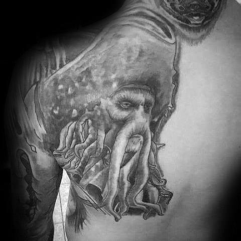 Black and gray tattoo of a Cthulhu figure, echoing Davy Jones, on a person's back