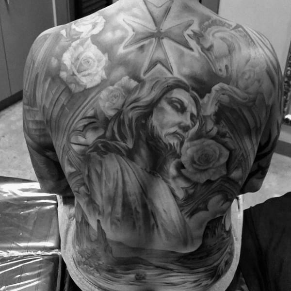 Male Back Tattoo Of Jesus Christ With Shaded Black And Grey Ink