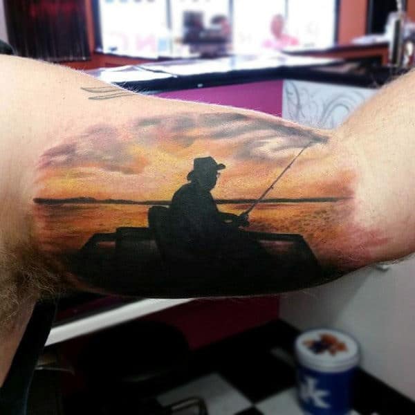 Male Bicep Tattoo Man Fishing On Lake At Sunset