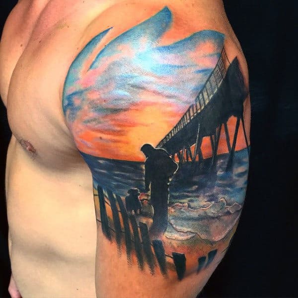 Male Bicep Tattoo Of Man And Dog At Sunset