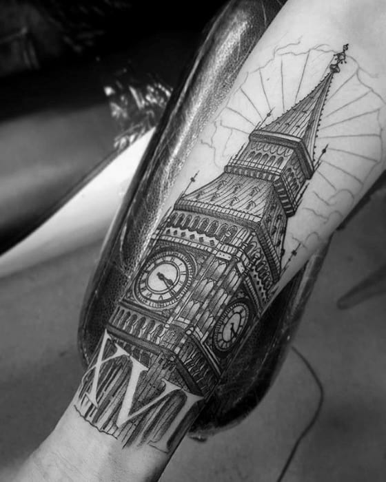 Detailed black and grey tattoo of Big Ben, with sun rays emerging from behind the clock tower, highlighting intricate shading and architectural details on the forearm.